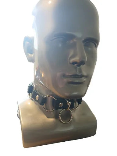 Black choker with silver accents on a mannequin head against a white background