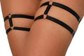 Black garter straps on a person's legs with a white background