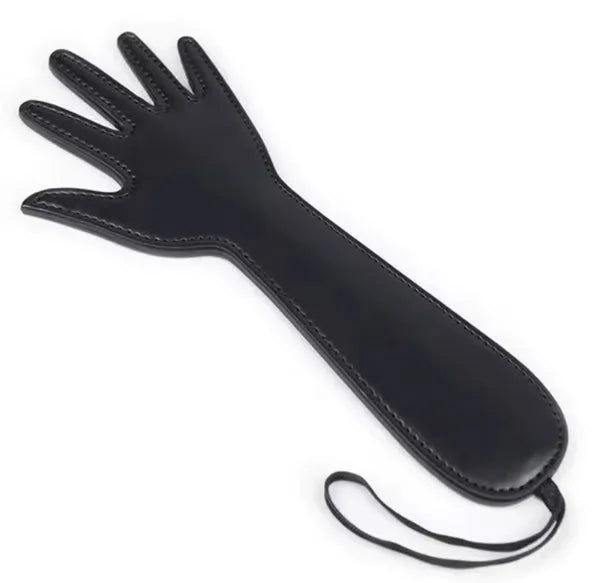 A black leather paddle with a strap, designed for adult use.